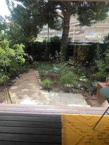 a view of a garden from a window at F3 avec jardin et piscine in Montpellier