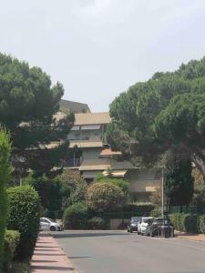 a parking lot with cars parked in front of a building at Chez Alexandra in Montpellier