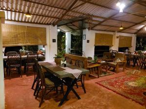 a dining room with a table and chairs at Grand Narmada Homestay Resort-Bandhavgarh in Tāla