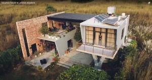 an aerial view of a house with solar panels on it at Jolshiri Vacation House in Dhaka