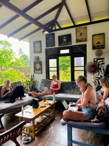 a group of people sitting on couches in a room at Wake Up Weligama in Weligama