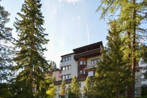 a building with trees in front of it at Miraflor Sonja by Arosa Holiday in Arosa