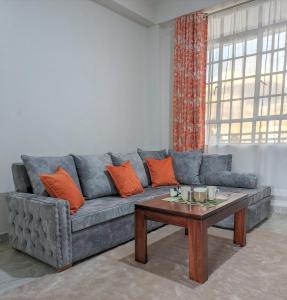 a living room with a couch and a coffee table at Cozy Homestays Meru in Meru