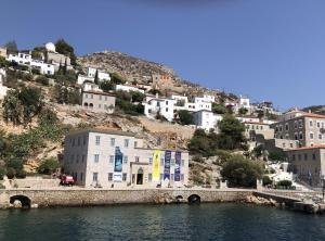 a group of buildings on a hill next to a body of water at Villa Hydra Estrella in Hydra