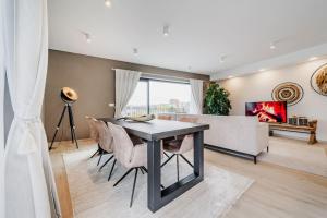 a living room with a table and a couch at L'appart Baobab, avec sauna in Liège