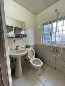 a bathroom with a toilet and a sink at Yilan B&B in Jincheng +60 photos