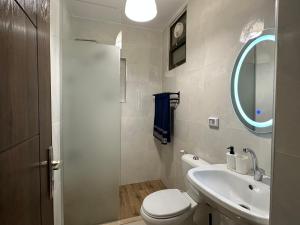 a bathroom with a sink and a toilet and a mirror at Alsadi Housing- Mecca Street in Amman +34 photos
