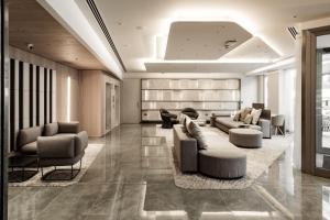 a lobby with couches and chairs in a building at AC Hotel by Marriott St Julian's in St. Julianʼs