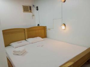 a bed in a room with two towels on it at WJV INN JY in Cebu City