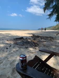 a can of soda sitting on a bench on the beach at Changthong Bungalow in Koh Chang Ranong