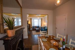 a dining room with a table and a mirror at 4-bed botanical retreat in Plymouth