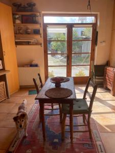 a dog standing in a room with a table and chairs at Avli-the courtyard in Nicosia