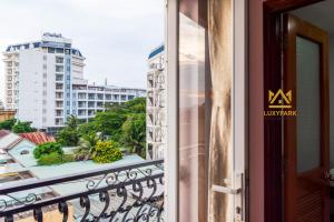 a balcony with a view of a city at Luxy Park Hotel & Residences - Phu Quoc City Centre in Phú Quốc