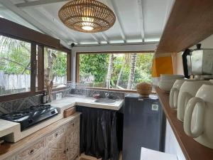 a kitchen with a sink and a stove and a window at villa kayu keluarga lilas in Ubud