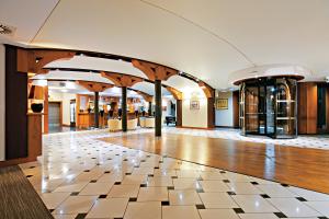 a lobby with a checkered floor in a building at Łeba Hotel & Spa in Łeba