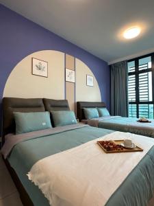 a bedroom with two beds with blue walls at Green Haven 1 Bedroom in Masai