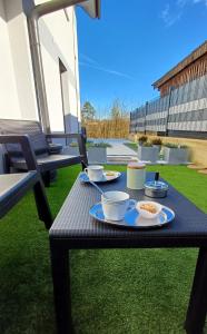 a picnic table with food on it on the grass at Apartmaji STARS in Mavčiče