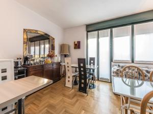 a kitchen and living room with a table and chairs at Mini Hotel Wine & Dreams in Alba