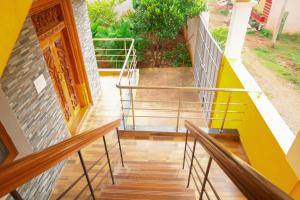 a staircase in a house with a yellow railing at Prabas - Farm house in Puducherry