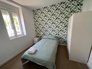 a small bedroom with a bed and a wall at Casa Rural La Granja de Torrehermosa TR-BA-00291 in Granja de Torrehermosa +27 photos