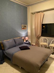 a bedroom with a bed and a window at The A project, Deluxe Suites in Agria