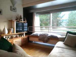 a living room with a couch and a large window at La Casa Shabby in Marilleva