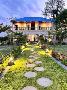 a pathway in front of a house with a building at Jewel of Jungle in Tāla