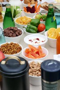 a table topped with bowls of different foods and bottles at Jewel of Jungle in Tāla