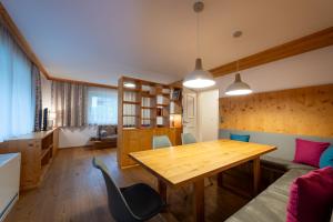a dining room with a wooden table and chairs at Chalet Georg in Kaprun
