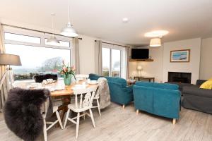 a living room with a table and chairs and a couch at Fleet View in Gatehouse of Fleet