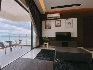 a living room with a view of the ocean at Seafront Country Garden Danga Bay by Lions Bay in Johor Bahru