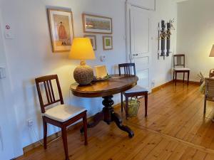 a room with a table with chairs and a lamp on it at 1912 - Wooden Room apartment - old town in Locarno +16 photos