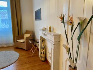 a living room with a fireplace and a vase with flowers at 1912 - Wooden Room apartment - old town in Locarno