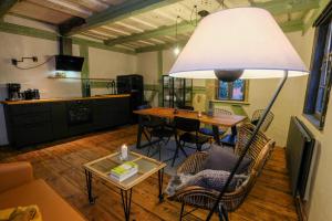 a living room with a table and a large lamp at Renaissance-Fachwerkhaus in Torgau