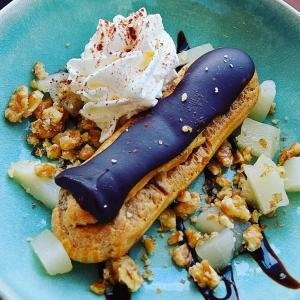 a blue plate with a desert with ice cream and nuts at Hôtel La Croisette & Restaurant Bistrot Gantier in Royan