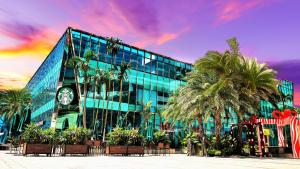a large glass building with a clock on it at Seafront Country Garden Danga Bay by Lions Bay in Johor Bahru