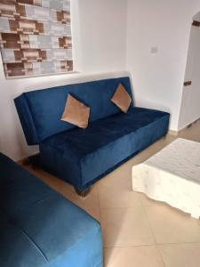 a blue couch with two pillows in a living room at House with backyard in dahab in Dahab