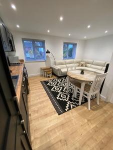 a living room with a table and a couch at Private luxurious apartment in Easthampstead