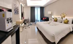 a hotel room with a large bed and a living room at Genting Ion Delemen by Horizon Homes in Genting Highlands