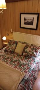 a bedroom with a bed with a quilt on it at Baita Tre Querce in Viggiano