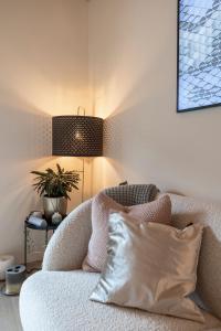 a living room with a couch with a pillow and a lamp at La Ruinette - Modern 2 Bed, Close To The Lift in Le Châble