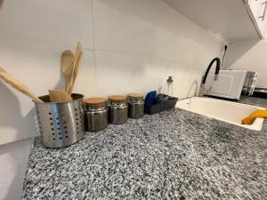 a kitchen counter with several pots and pans on it at עלמה in Tel Aviv