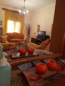 a living room with a table with oranges on it at Antonioy Apartment Metewra in Kalabaka