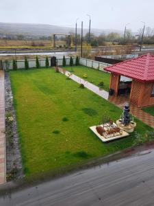 a grassy area with a gazebo next to a street at Casa de inchiriat in Vaslui in Vaslui