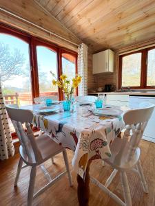 a kitchen with a table with a tablecloth on it at Mallard Lodge - Arscott Lodges in Shrewsbury