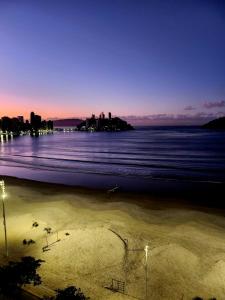 - une vue sur la plage et la ville la nuit dans l'établissement frente ao mar, à São Vicente