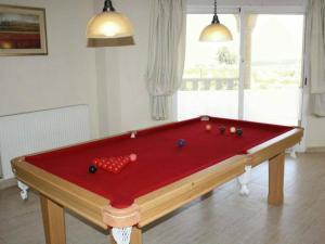 a red pool table with balls on top of it at Villa del Rio in Campos del Río