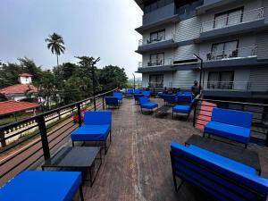 a row of blue benches in front of a building at JW HERITAGE in Anjuna