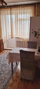 a living room with a table and a rug at Sweet Home 2 in Atyrau