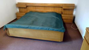 1 cama con marco de madera en una habitación en Ferienwohnung Villmar en Villmar